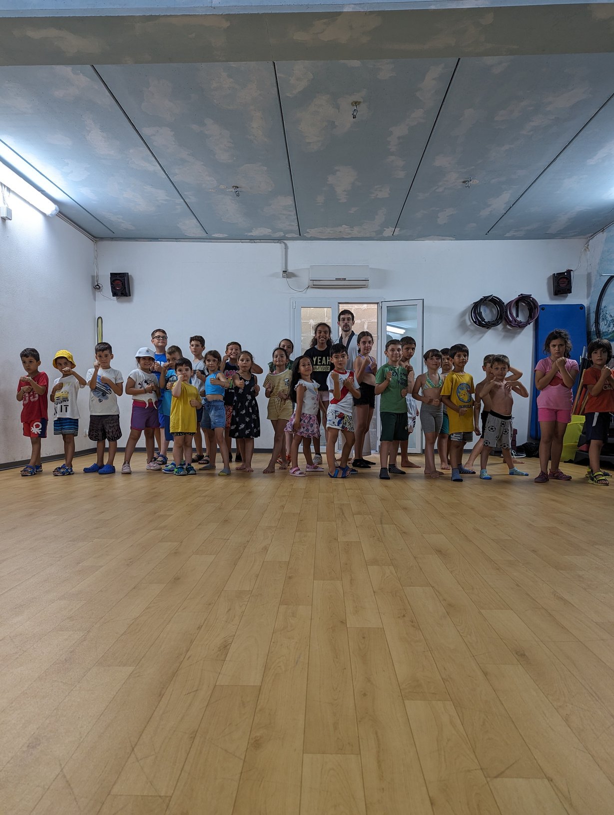 a group of children posing for a photo in a dance studio