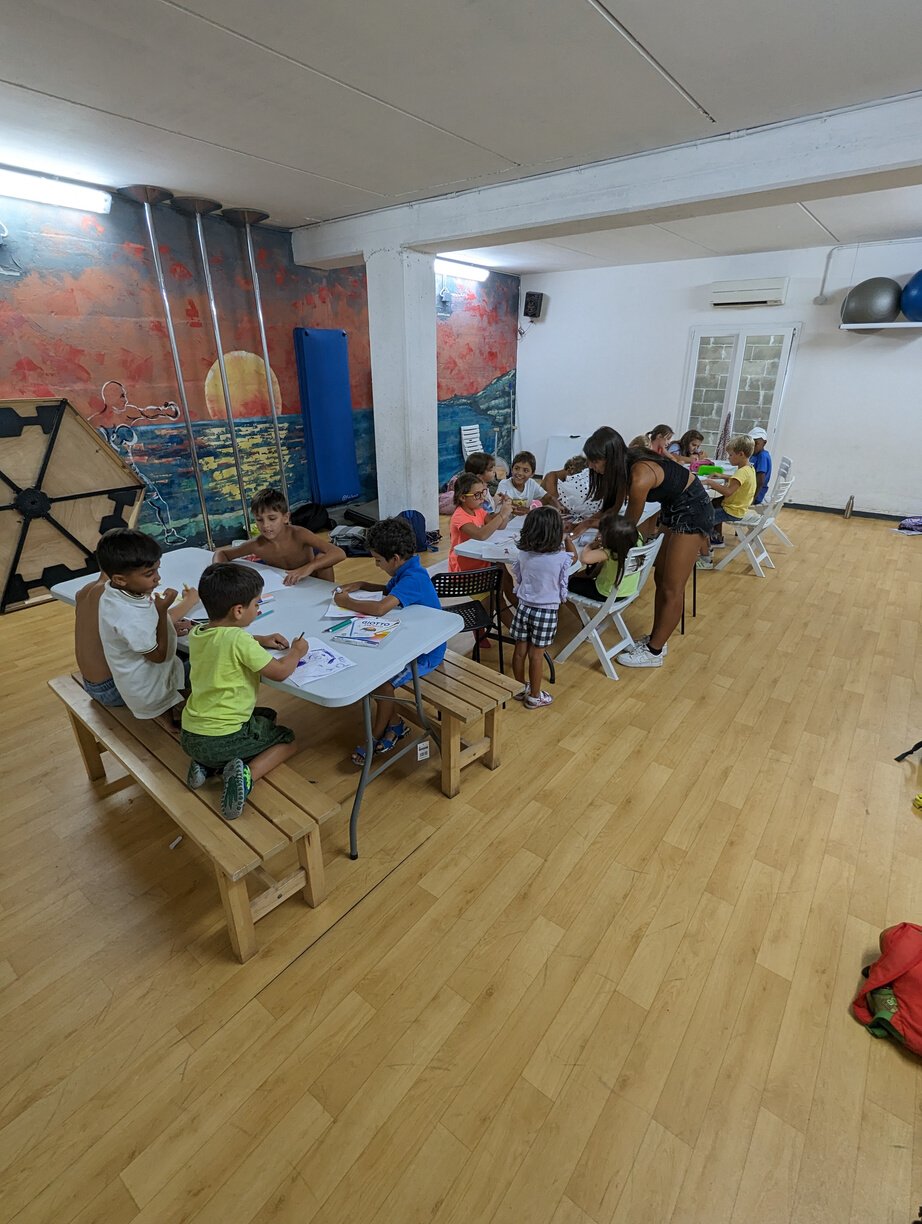 a group of children sitting at tables in a room